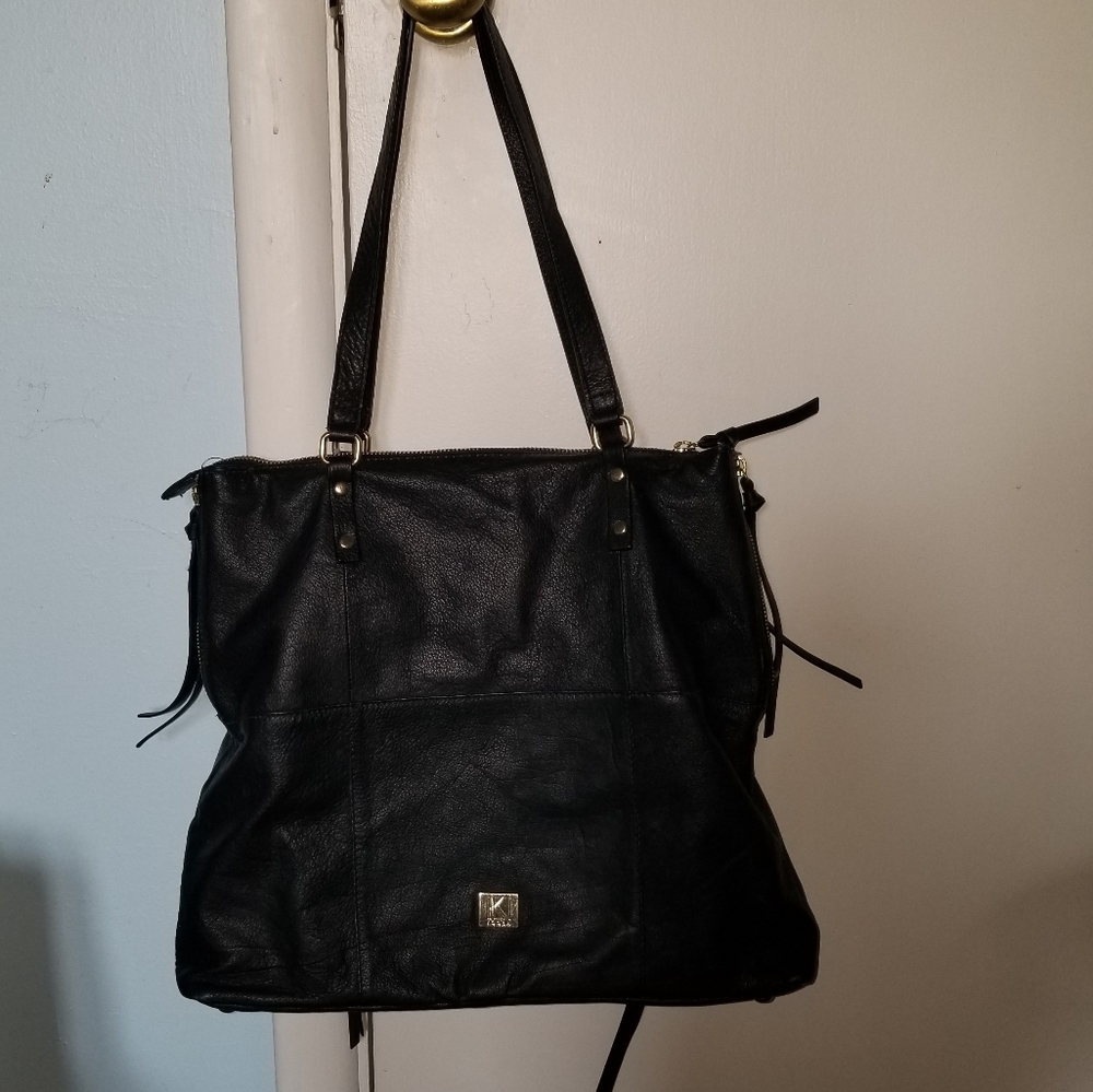 Black purse with geometric pink interior